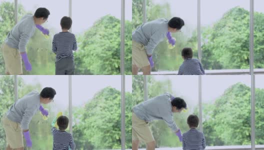 肖像的亚洲父亲和小儿子在橡胶手套与洗涤剂和抹布清洗窗户玻璃一起。男孩帮爸爸打扫房子。日常工作的概念。高清在线视频素材下载