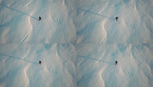 人在新粉雪中穿雪鞋4K超高清航拍视频高清在线视频素材下载