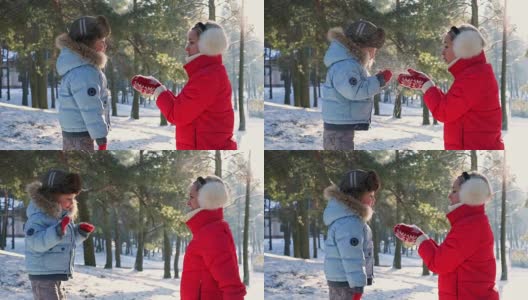 冬姑娘在红彤彤的雪中吹着手心，在温暖的夕阳下高清在线视频素材下载