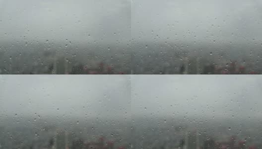 透过玻璃窗外的城市景观与雨滴在摩天大楼高清在线视频素材下载