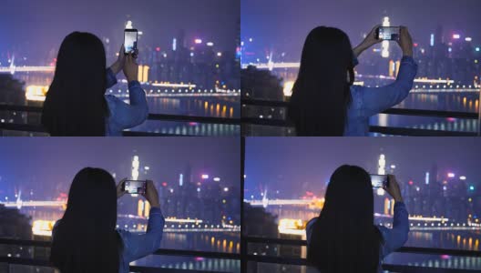 年轻女子正在拍摄城市夜景高清在线视频素材下载