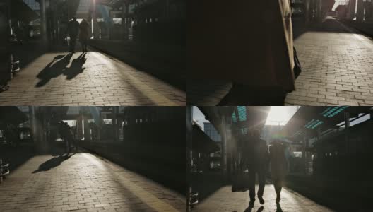 幸福的年轻情侣在火车站的月台上走到火车上，在最后一缕阳光下，浪漫情侣的剪影高清在线视频素材下载