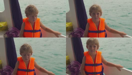 一个在潜水船上的小男孩在他第一次在公海浮潜之前感到紧张高清在线视频素材下载