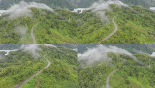 鸟瞰图的乡村道路通过绿色的森林和山高清在线视频素材下载