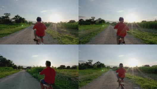 傍晚，孩子在乡间的路上骑着自行车高清在线视频素材下载