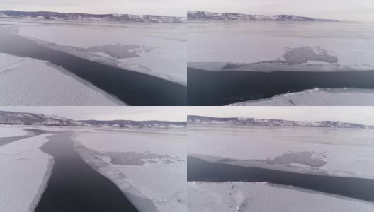 冻结贝加尔湖。贝加尔湖进入冬眠。贝加尔斯克冰冷的海岸，可以看到群山。自然背景。季节变化。无人机射击。高清在线视频素材下载