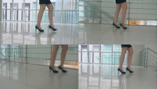 女商人穿着高跟鞋走在办公室的走廊里高清在线视频素材下载