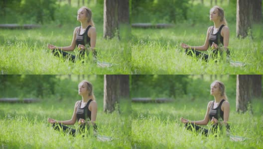 平静的运动女人享受阳光在草坪上瑜伽姿势高清在线视频素材下载