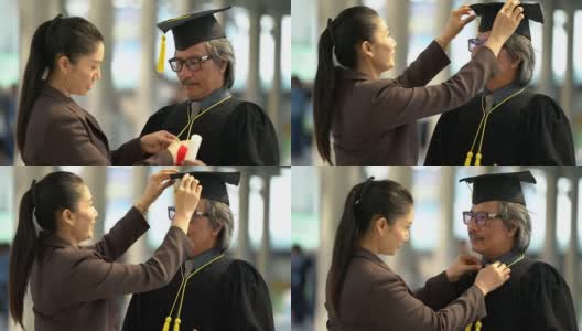 大四毕业生和他的妻子在准备毕业典礼的帽子长袍。高清在线视频素材下载