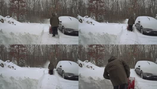 一场冬季暴风雪过后，一名男子正在清理他被雪覆盖的汽车周围的车道。高清在线视频素材下载