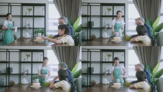 幸福亚洲家庭早餐，亚洲妻子丈夫和儿子一起坐在餐桌家庭内部背景一起吃早餐高清在线视频素材下载