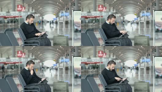 旅客在机场候机室使用平板电脑高清在线视频素材下载