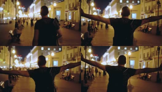 盖伊走在夜城的街道上，张开双臂，争取生命的自由高清在线视频素材下载