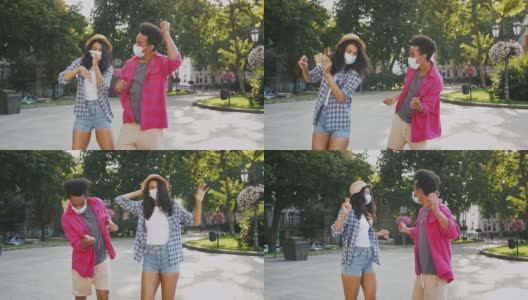 黑皮肤的男男女女戴着防护面具在城市公园跳舞高清在线视频素材下载