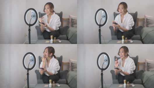 一位美丽的亚洲化妆博主正在家中直播如何化妆高清在线视频素材下载