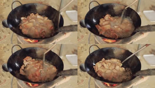炸猪肉在金属锅和热油特写。对泰国人来说是非常美味的食物和小吃。高清在线视频素材下载