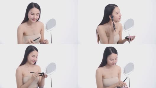 一位亚洲女性博主正在展示如何化妆和使用化妆品。在摄像机前录制视频直播流媒体在工作室高清在线视频素材下载
