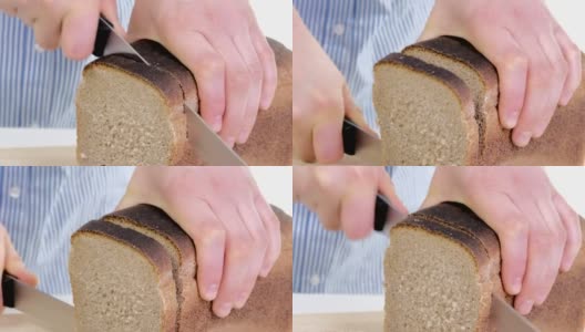 女性的手正在切新鲜的面包高清在线视频素材下载
