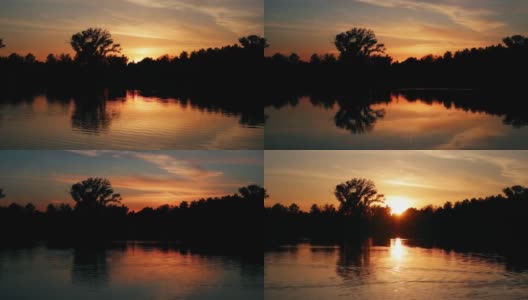 美丽的日落在森林附近的湖。间隔拍摄。高清在线视频素材下载