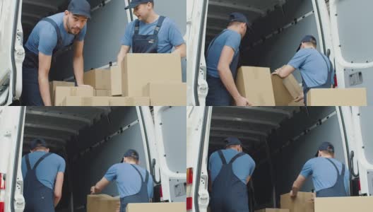 两名强壮的送货员慢动作装载商业车辆的硬纸盒。高清在线视频素材下载