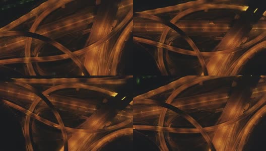 夜间照明多层次路口及车辆通行。无人机旋转着飞起来。空中垂直拍摄。高清在线视频素材下载