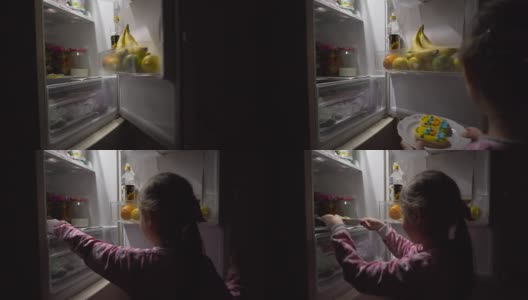 小女孩从冰箱里拿出饼干。高清在线视频素材下载