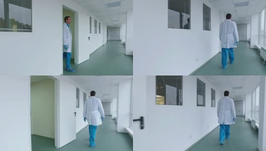 科学家行走在实验室走廊上。医生步行医院走廊的后视图高清在线视频素材下载