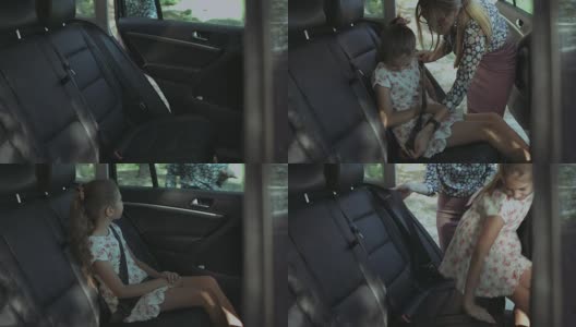 关心的母亲系女孩在汽车上的安全带高清在线视频素材下载