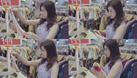 一位年轻女子在一家服装店购物高清在线视频素材下载