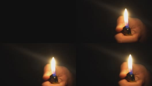 一个男人在黑暗中点燃打火机的特写镜头。慢动作拍摄高清在线视频素材下载