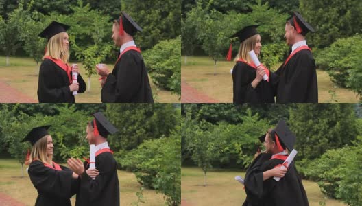 高兴的女人和男人在毕业典礼后的学术服装拥抱高清在线视频素材下载