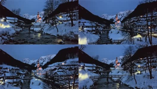 冬天的早晨，在德国巴伐利亚阿尔卑斯山的拉姆绍，贝希特斯加登，著名的圣塞巴斯蒂安教区教堂附近的步行桥。高清在线视频素材下载
