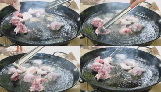 西班牙海鲜饭的制作过程，用滚烫的橄榄油在平底锅里煎兔肉高清在线视频素材下载
