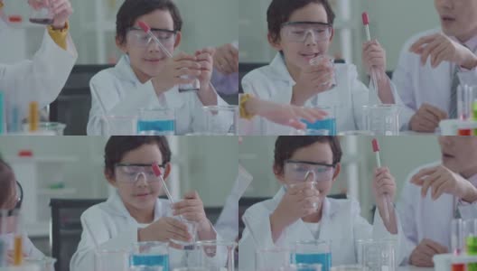 穿着科学家制服的亚洲孩子们玩得很开心。学习科学实验室实验试管玻璃水在桌子上各种颜色高清在线视频素材下载