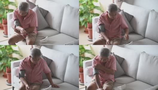 亚洲华人老年男子正在监测血压高清在线视频素材下载