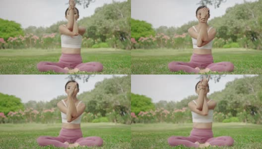 一位年轻的亚洲女子坐在花园里练瑜伽，她很放松，很享受锻炼。高清在线视频素材下载