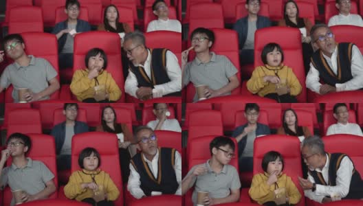 一位亚洲华人爷爷和他的孙子们喜欢在电影院看电影。高清在线视频素材下载