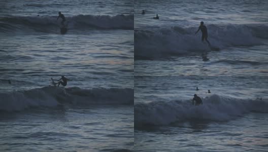 日本濑户岛，日落时冲浪者在海里的视频素材高清在线视频素材下载