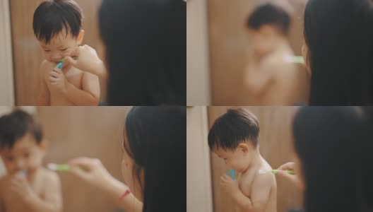 可爱的男孩在学自己刷牙。高清在线视频素材下载