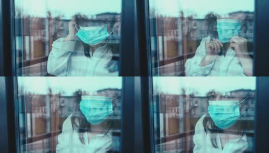 一名妇女戴上医用口罩，看着窗外的街道，车窗外有汽车驶过高清在线视频素材下载