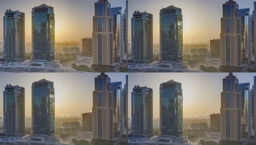 鸟瞰图朱美拉湖塔摩天大楼在日出时间与交通在谢赫扎耶德路高清在线视频素材下载