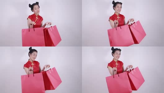 快乐的女人拿着购物袋庆祝春节高清在线视频素材下载