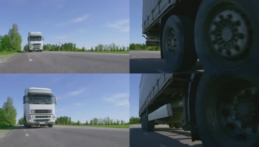 十八辆卡车开在空旷的乡村公路上，经过摄像头，车轮旋转。高清在线视频素材下载
