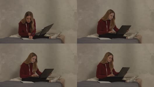 可爱的女学生拿着笔记本电脑在卧室里学习高清在线视频素材下载