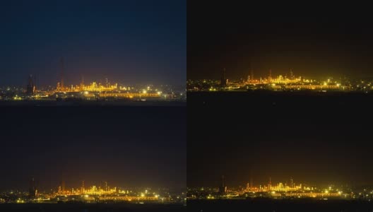 4 k间隔拍摄。一个发光的炼油厂的夜景，就像一个背景高清在线视频素材下载