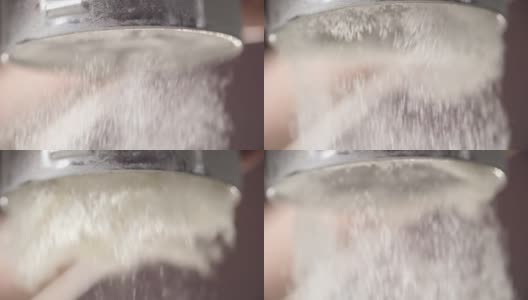 用筛子筛面粉的慢镜头。高清在线视频素材下载