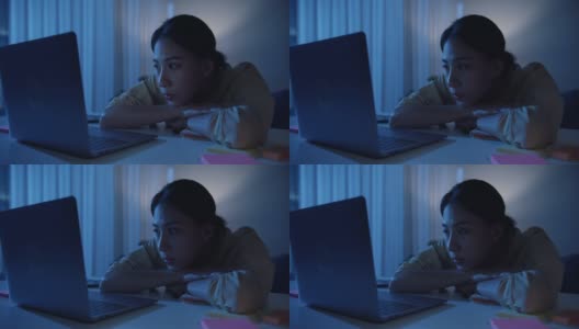 亚洲商务女性穿着休闲服装，晚上在家里客厅看笔记本电脑。近距离射杀。高清在线视频素材下载