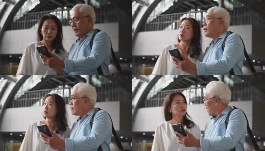 一对中国老年夫妇在用智能手机上的导航应用高清在线视频素材下载