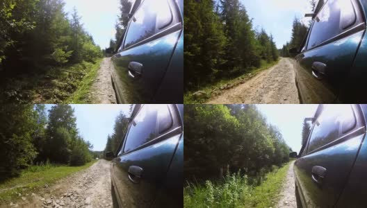绿色汽车行驶在破旧的石头路在农村地区的木材。夏天的时间高清在线视频素材下载