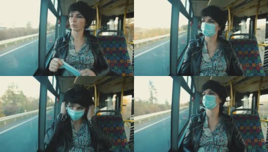 公共汽车副驾驶座上的一名妇女戴着口罩。高清在线视频素材下载